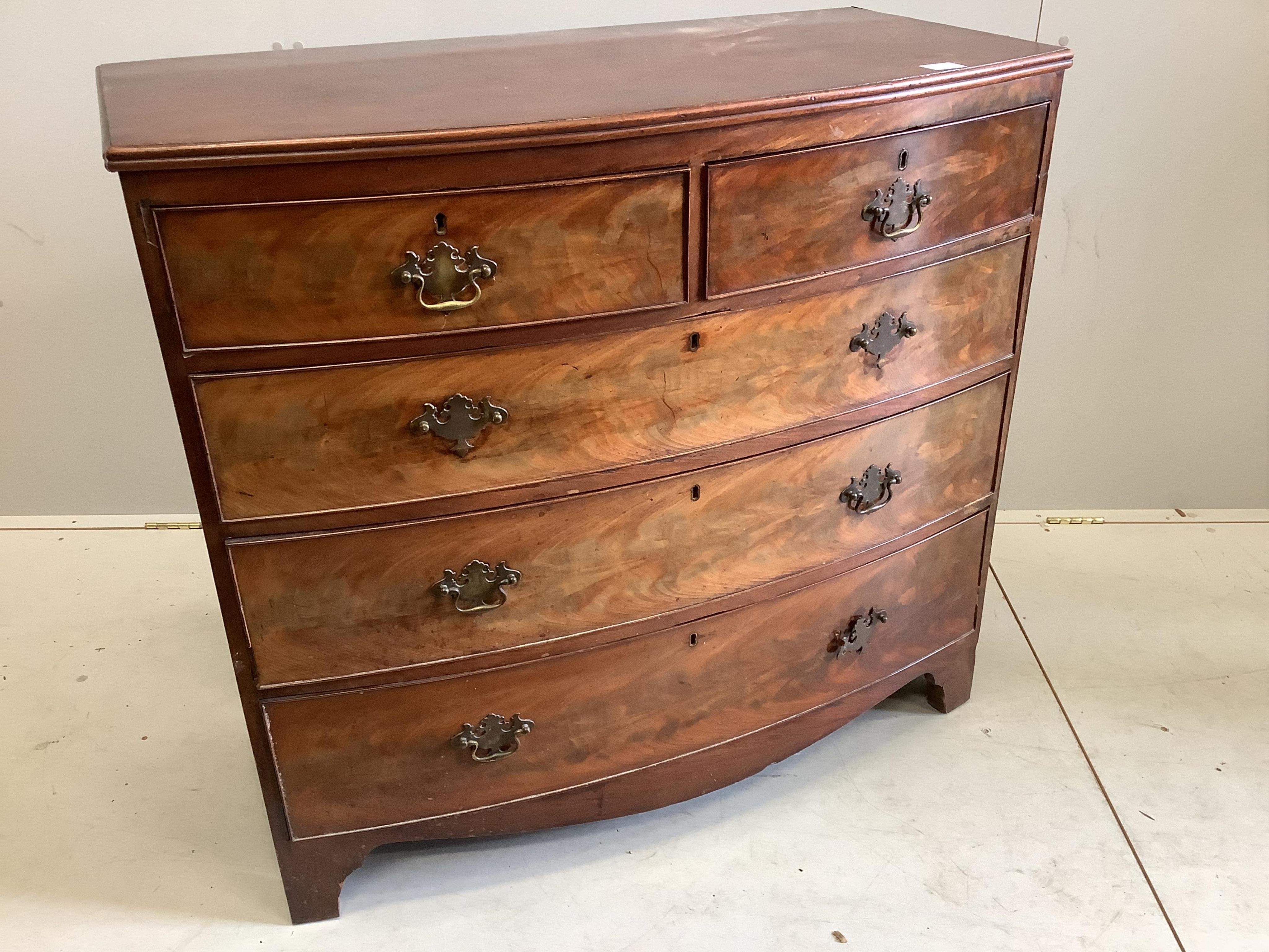 A Regency mahogany bow front chest of two short and three long drawers, raised on bracket supports, width 105cm, depth 53cm, height 96cm
